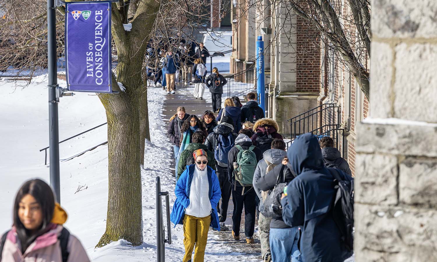 Students walk past Medbery Hall on their way to class. 