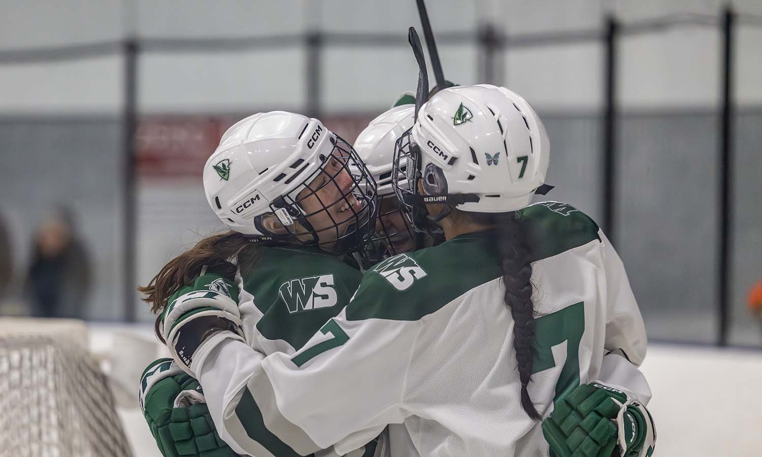 Fiona Gallagher ’26 and Anna Tardiff ’28 celebrate with Rowan Kennedy ’28 after Kennedy scored the third goal in William Smith ice hockey’s 4-1 win over Morrisville. 