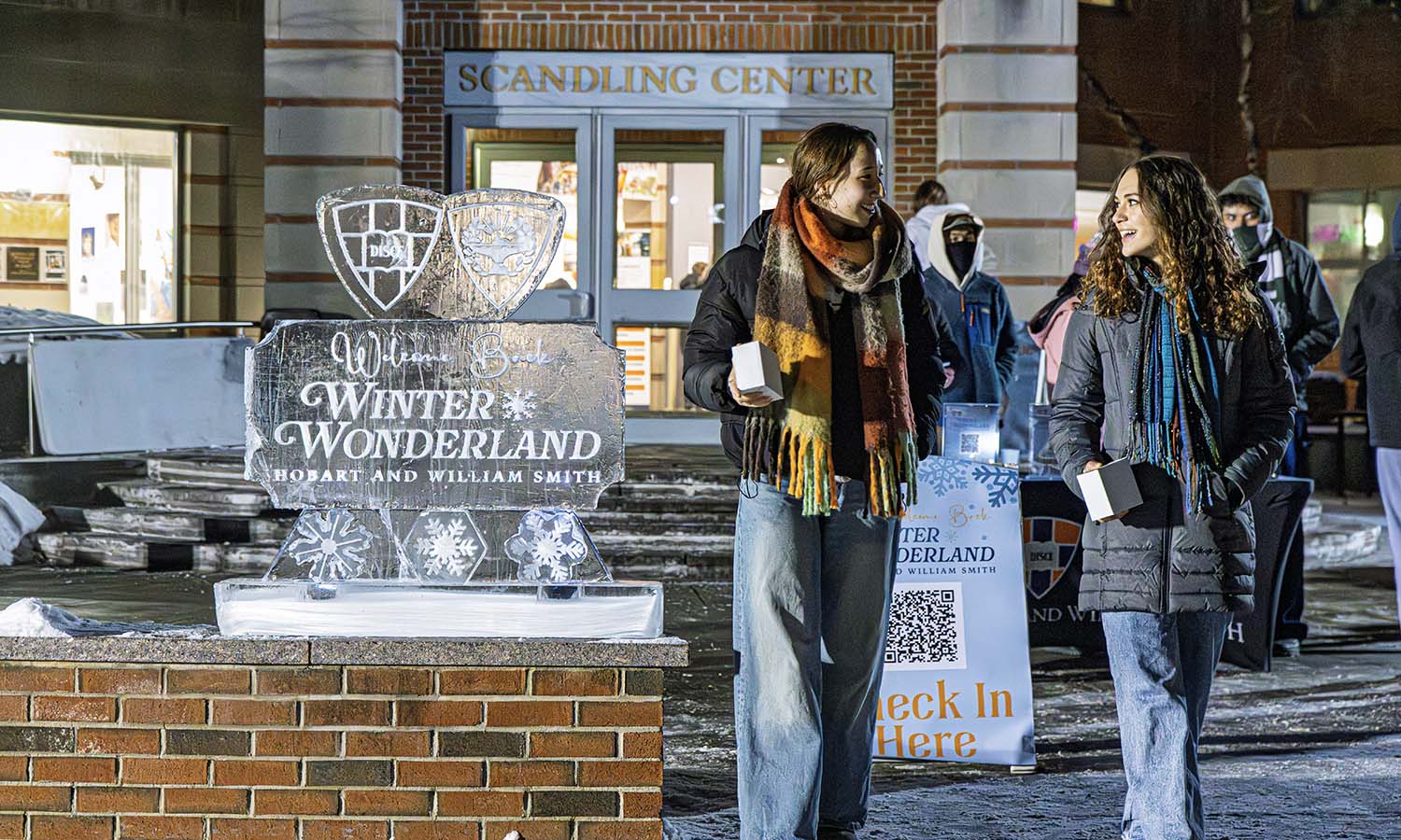 Students walk past the Winter Wonderland ice sculpture outside of Scandling Campus Center. 