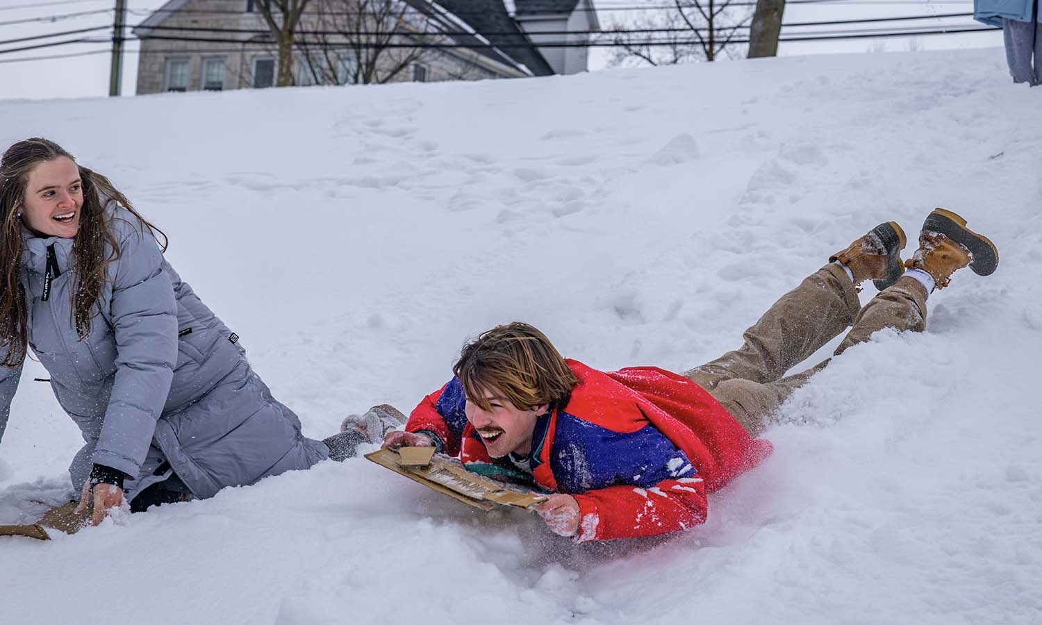 Lauren Campbell ’28 and James Courtney '29 sled down the hill towards Bozzuto Boathouse while filming the HWS Sailing team Athletics Day of Donors video. 