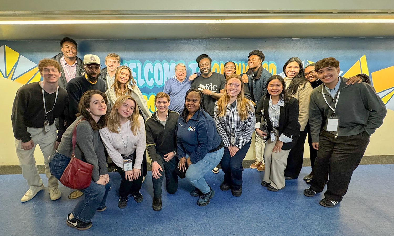 On a Philanthropy and Service Career Trek to NYC, students pose for a photo with staff at the Flatbush Development Corporation, where they learned about the organization’s work providing food, housing, youth programs and small business support. The trip was made possible through the support of Mike Gantcher ’92 (center), who joined students on the visit. 