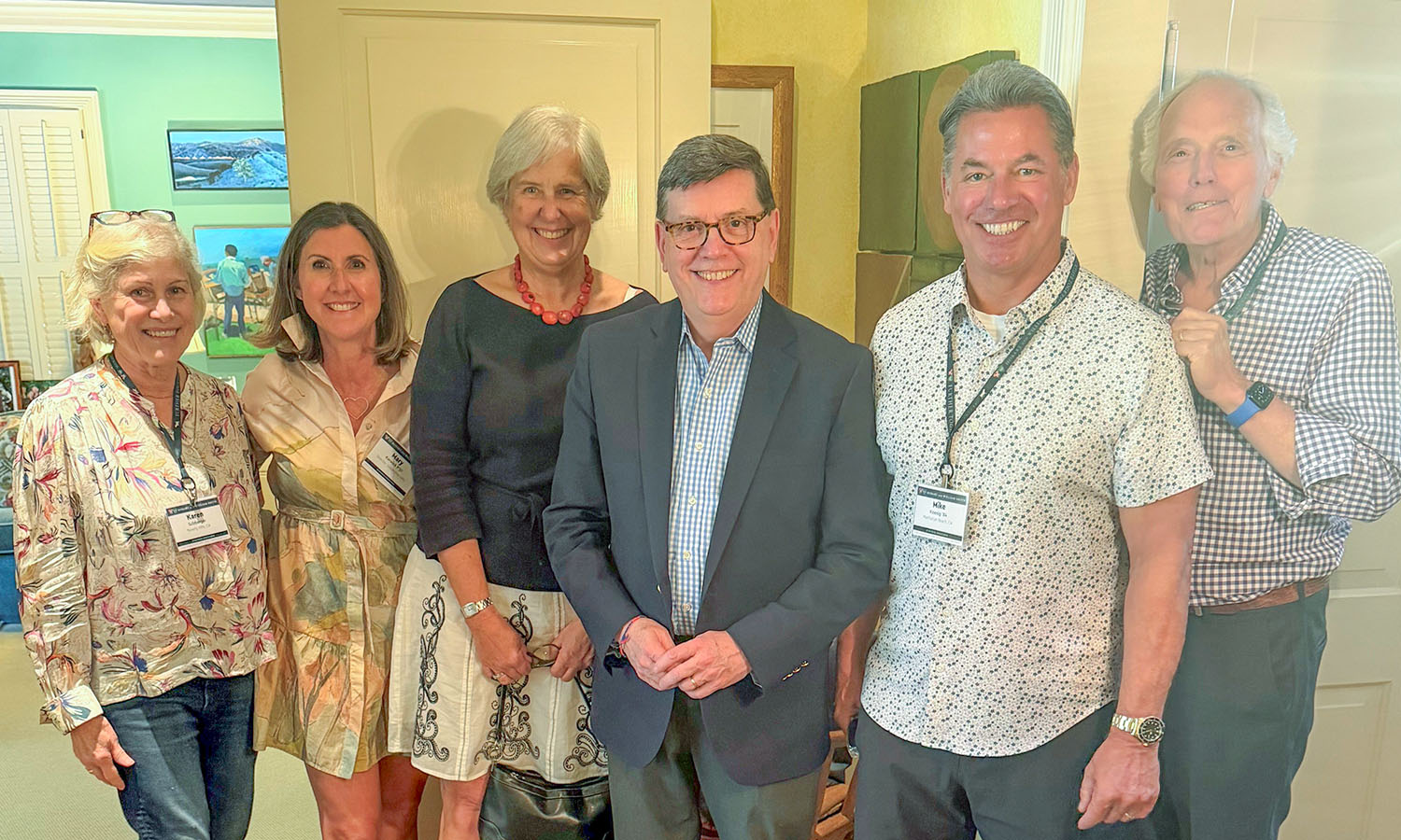 Hosts Karen Sulzberger (left) and Eric Lax ’66, L.H.D. ’93 (right) pose with Director of Leadership Giving Mary Morrissey Kerwick P’27, Aubin Wilson '84, President Mark D. Gearan, and Mike Koenig ’84 at a reception in their home. 
