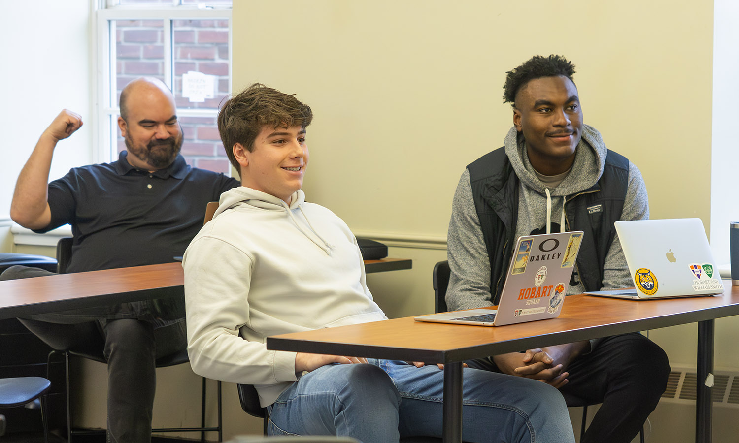 Javier De La Vega '26 and John-Michael Childs '28 listen during "Nonprofit, Philanthropy, and Impact" taught by Executive Director of the Center for Community Engagement and Service Learning Katie Flowers, Associate Professor of Business Management and Entrepreneurship Craig Talmage (left), and President Mark D. Gearan. 