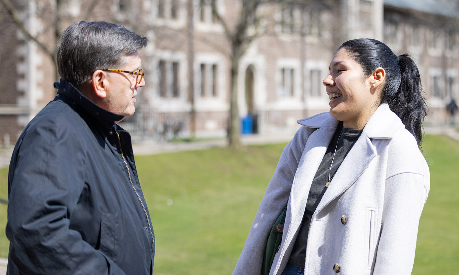 President Mark D. Gearan and Student Trustee Hailey Galvan '26 share a laugh on the Quad.&nbsp; 