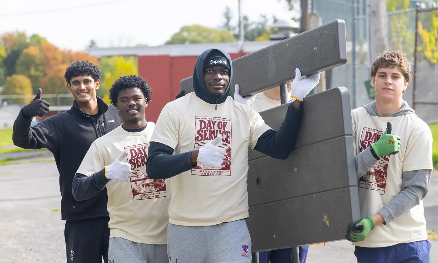 Members of the Hobart basketball team volunteer at the Challenger Baseball field during Fall Day of Service. 