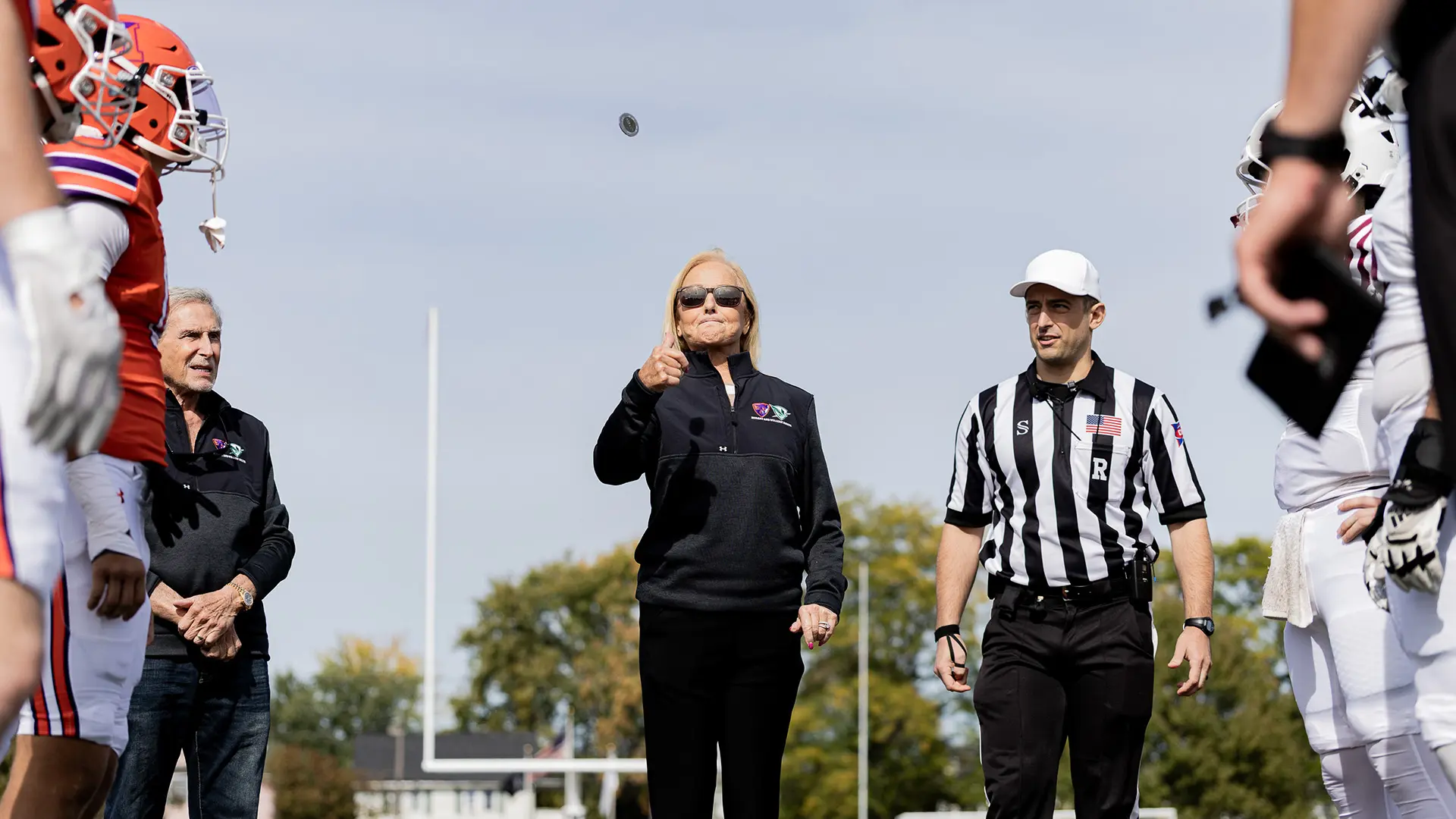 Stanley Gitelson and Cynthia Caird Gitelson L.H.D.’12 perform the coin toss before Hobart football’s win over Union College. Thanks to their gift, HWS will install a new 510-square-foot video board for Boswell Field. 