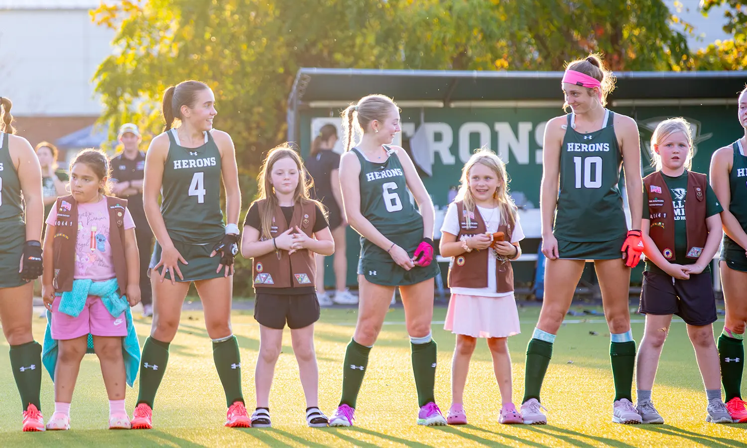 Girl Scouts join William Smith Field Hockey athletes on McCooey Field during player introductions before their game against Oswego. 