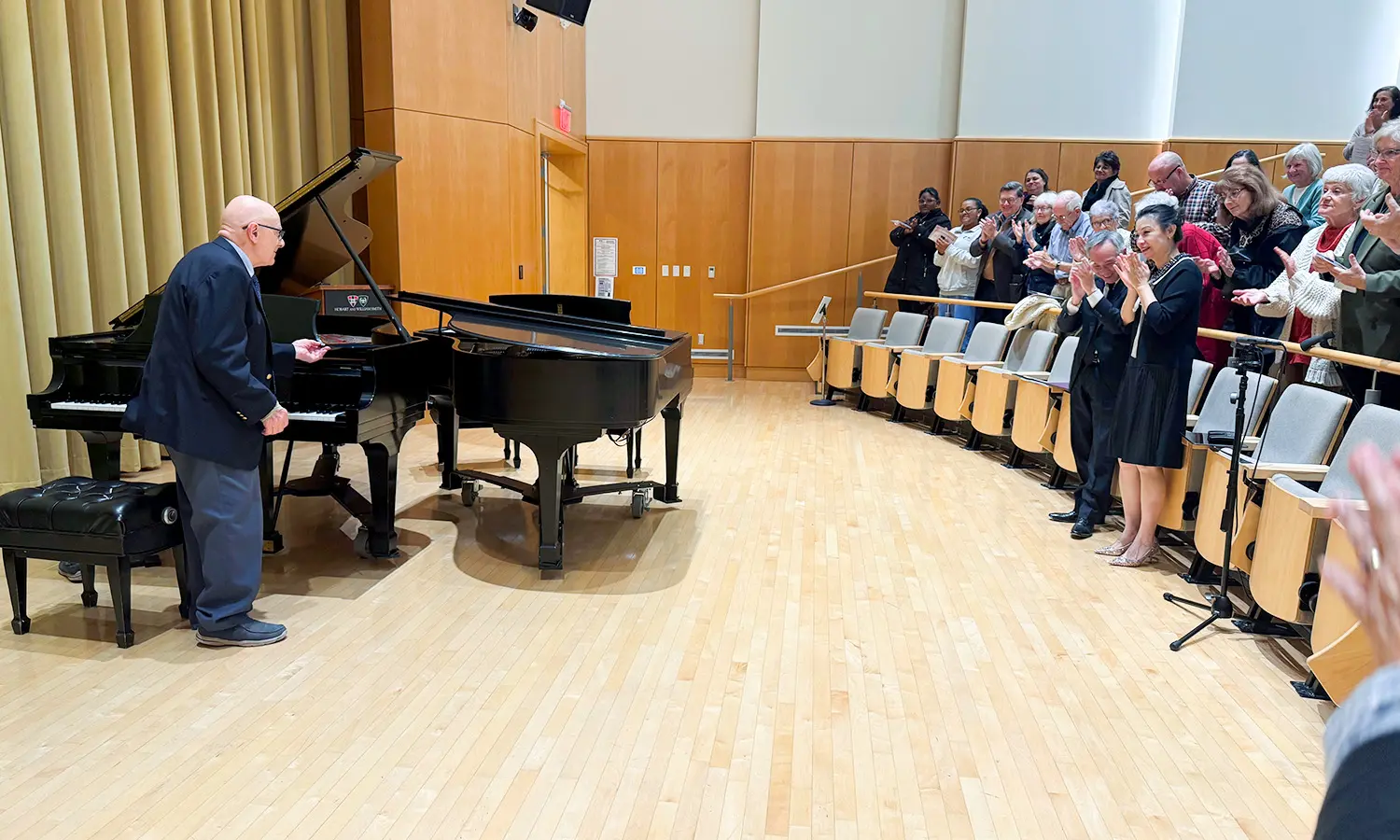 George Abraham '59 receives a standing ovation during "Opus 90 Completed - duo piano recital" held in Froehlich Hall in honor of his 90th birthday. 