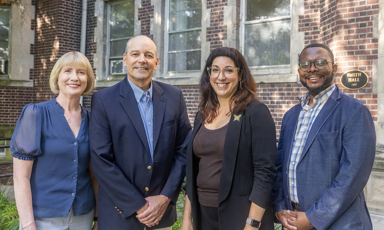   The four Hobart and William Smith Deans, Amy Green, David Mapstone ’93, P’21, Kelly Payne and Kelvin Clark pose for a photo outside Smith Hall.  