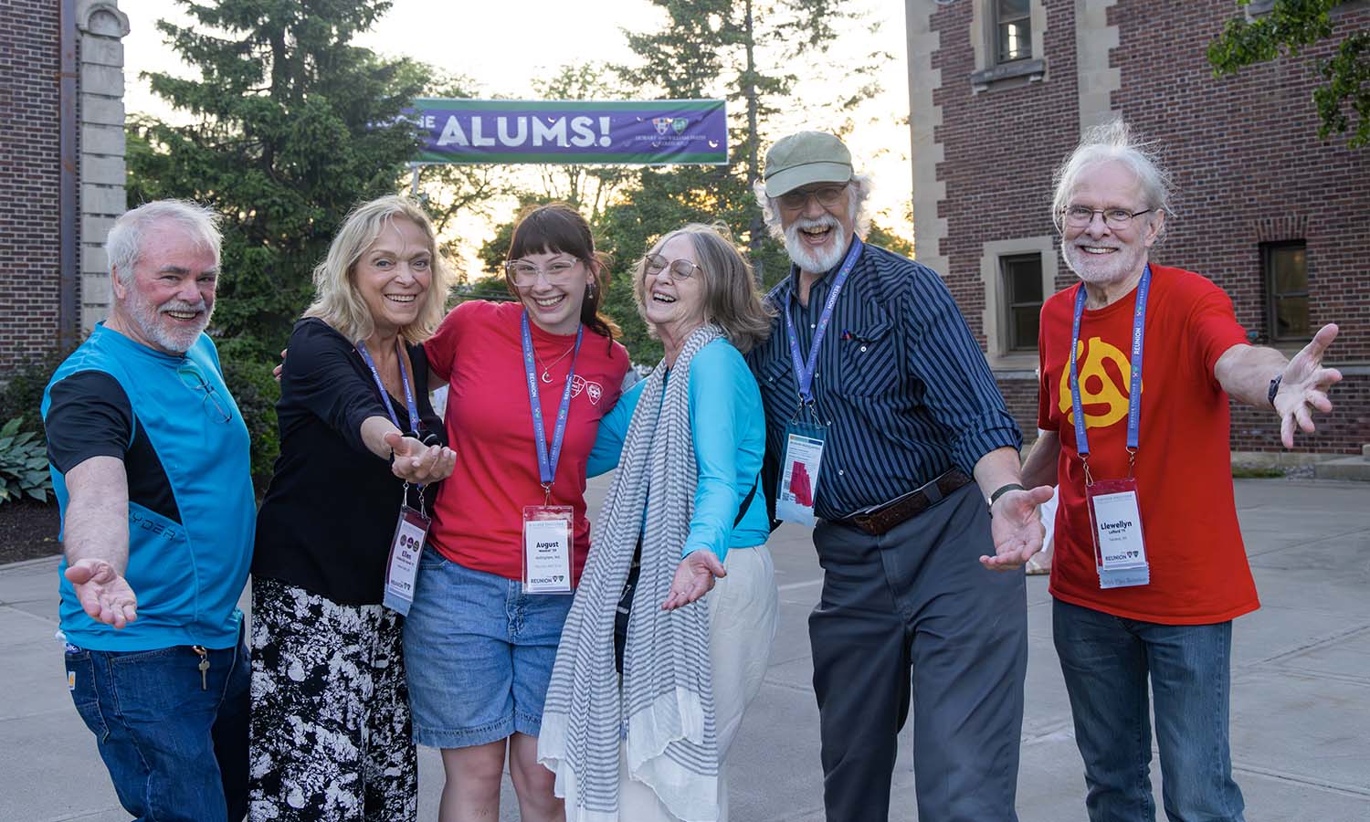 Members of the class of '71 pose for a photo with August Montiel '29, one of more than two dozen HWS students in “Red Shirts” on campus to help coordinate Reunion.  