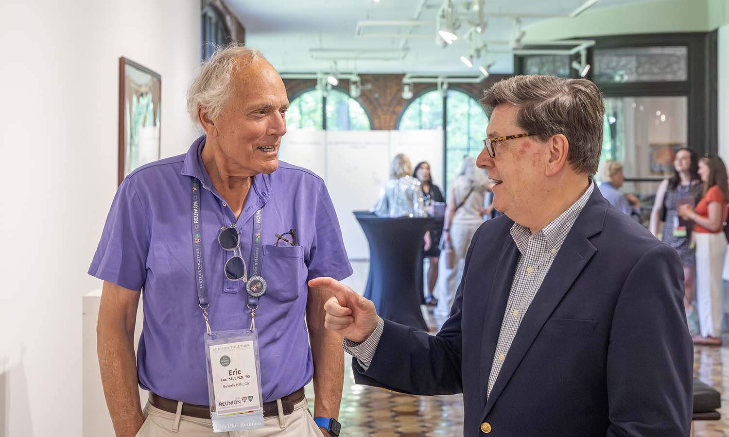 At the “Lives of Consequence: An Examination of HWS Alumni Service” exhibit in the Davis Gallery, President Mark D. Gearan chats with Eric Lax ’66, L.H.D. ’93. Lax served as a Peace Corps volunteer before embarking on a career as a best-selling author.  