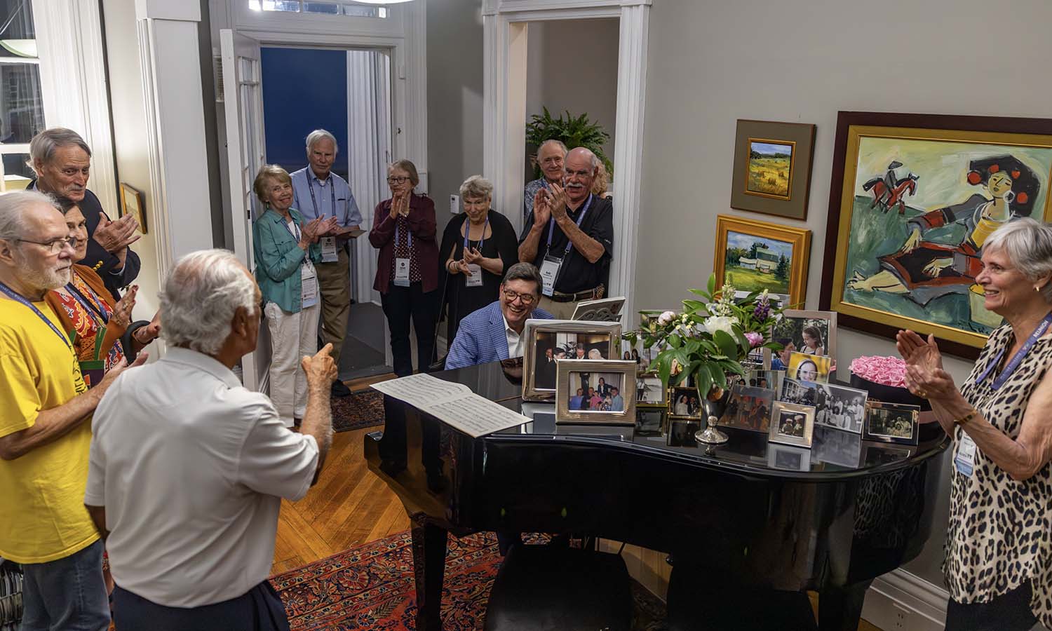 Joined by President Mark D. Gearan on the piano, Art Medici ’71 and classmates sing "Somewhere Over the Rainbow" during the Post-50th Reunion Classes dinner held at the President's home. 