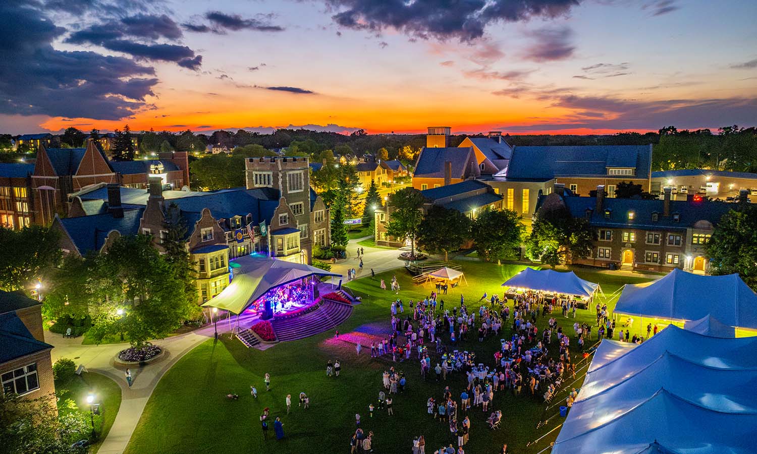The sun sets over the Quad party as the band Uptown Groove performs. 