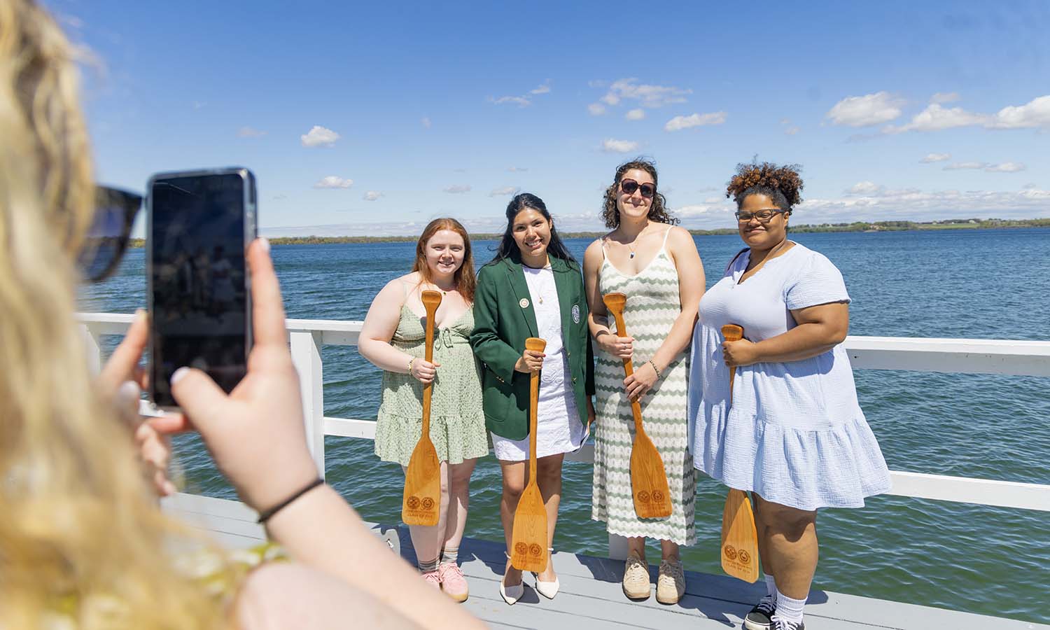 After receiving their paddles, Breanna Holland ’26, Hailey Galvan ’26, Olivia Crane ’26 and Cori Chapman ’26 pose for a photo. 