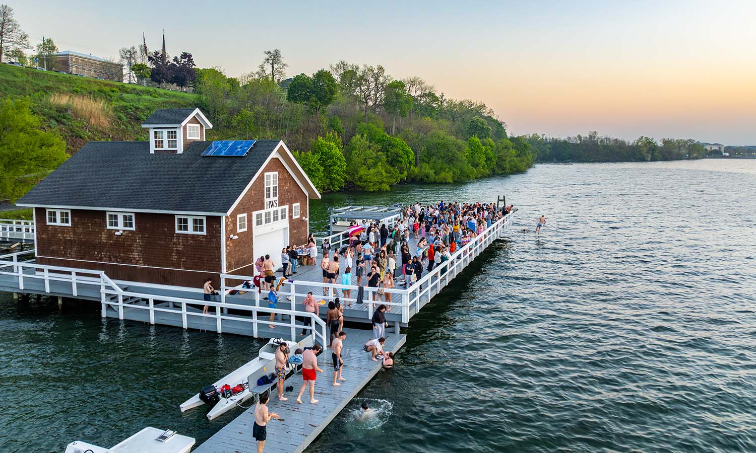 Seniors gather at the Bozzuto Boathouse to watch their last sunrise together and jump in Seneca Lake. 