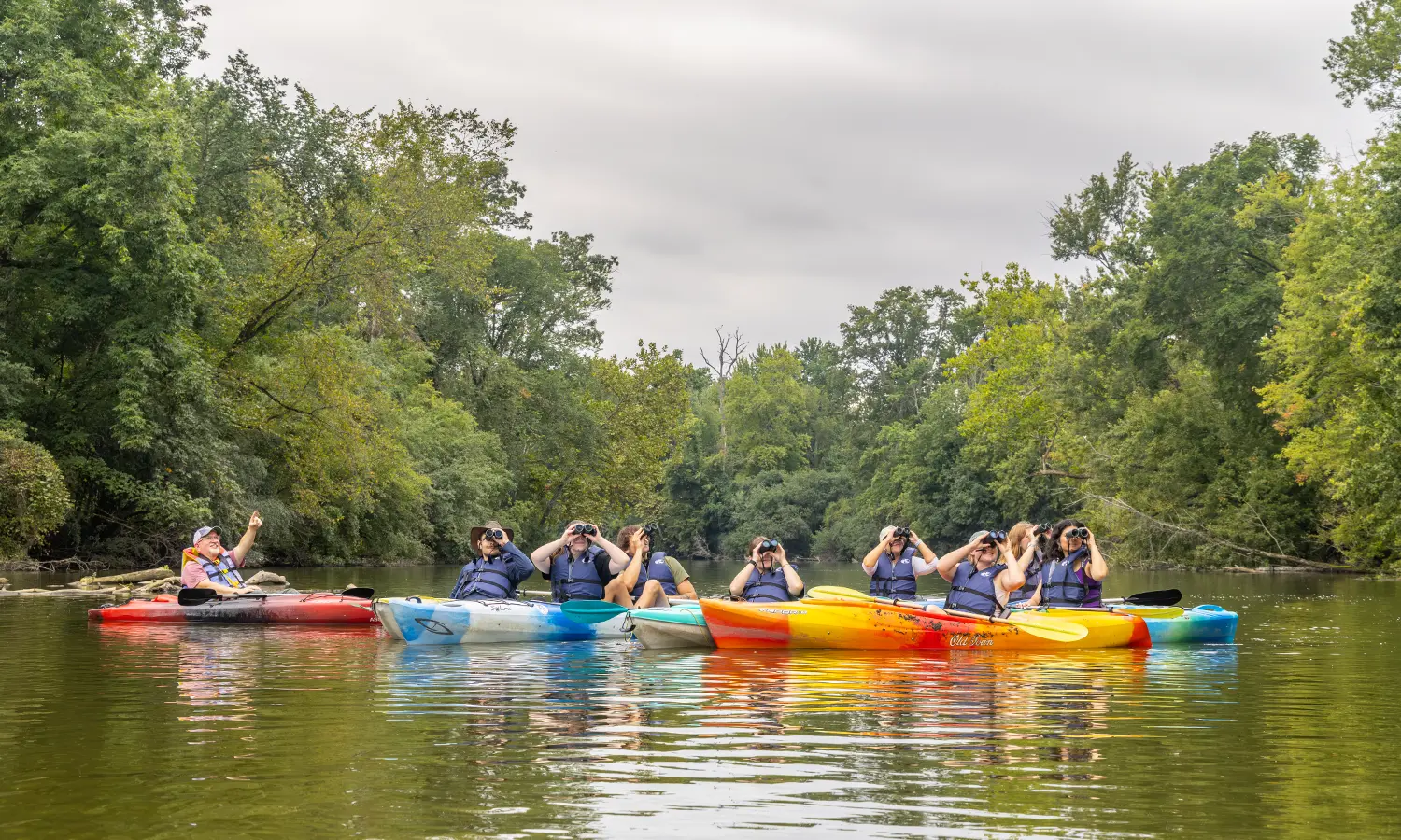 Professor of Biology Mark Deutschlander points out a bald eagle to students in “Ornithology” during a kayaking excursion down the Erie Canal with the Montezuma Audubon Society. 