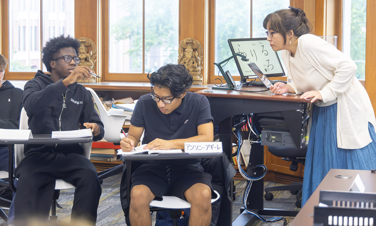 Teaching Instructor and Tanaka Lecturer Kyoko Klaus assists students practicing their writing in "Beginning Japanese." 