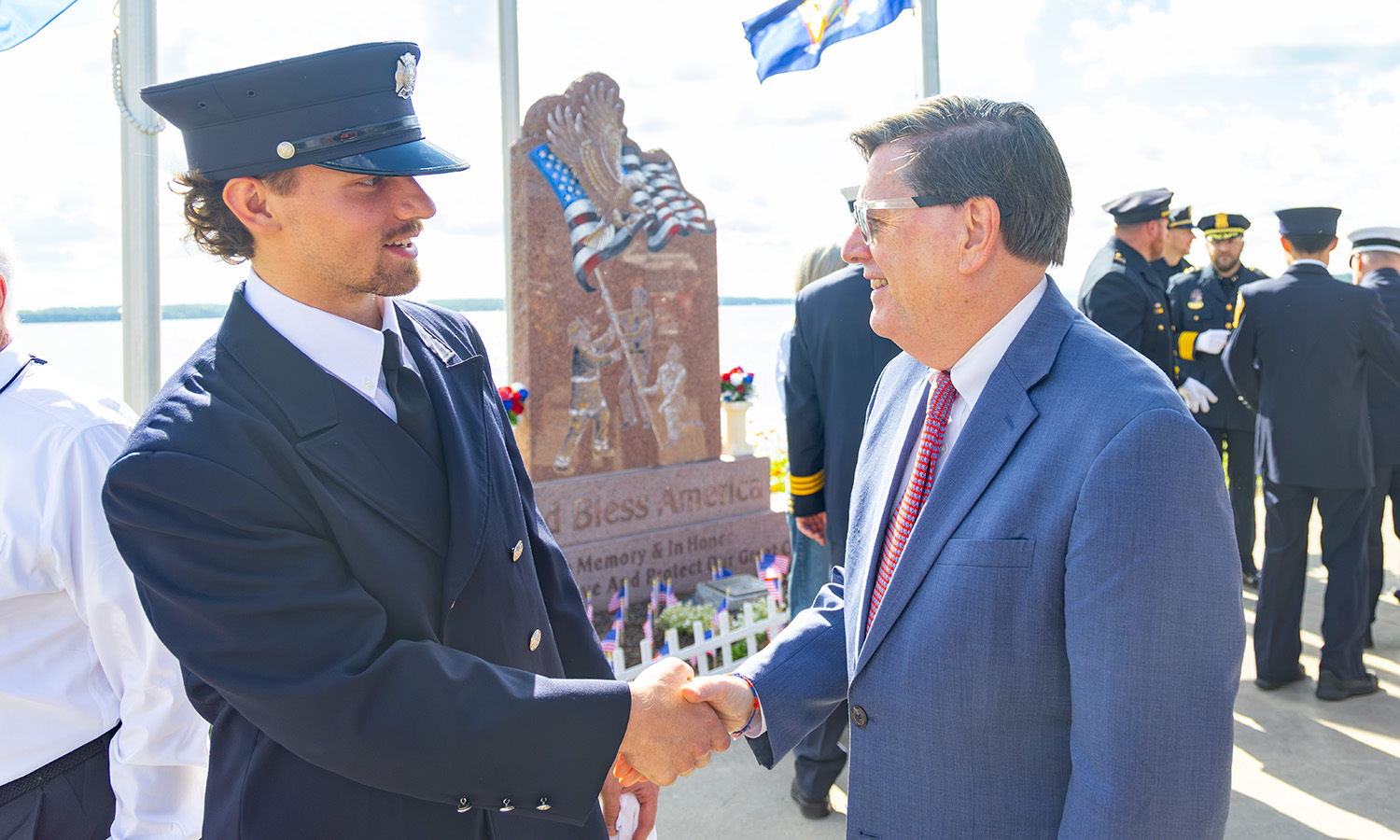 President Mark D. Gearan greets Gavin Brignall '27 at the Geneva 9/11 Memorial Service. Brignall is a member of Geneva's Volunteer Fire Department.  