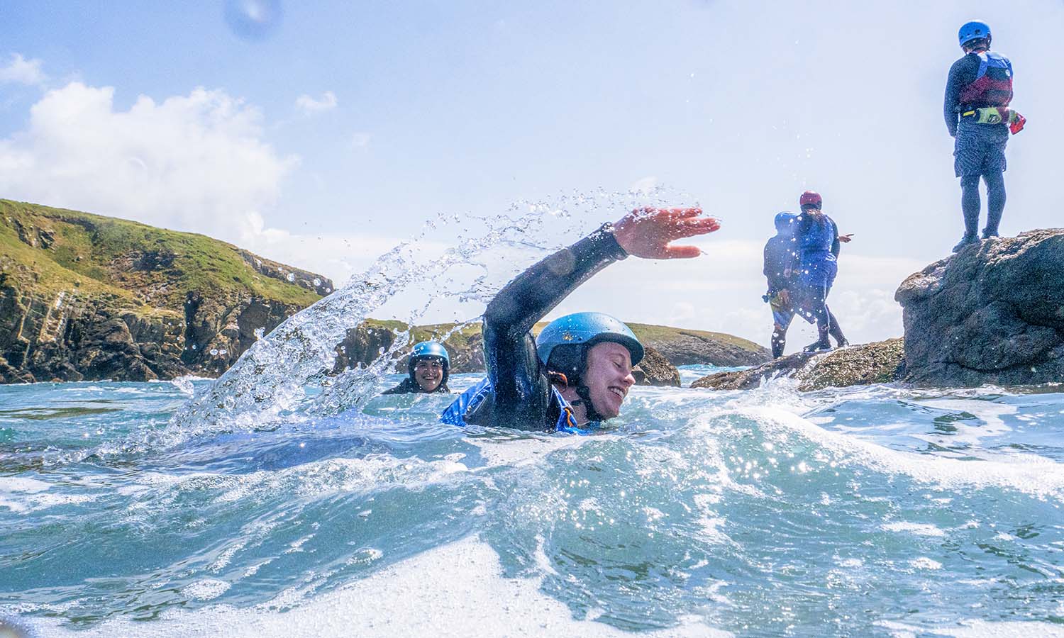 Bridget McCleary ’28 rides the tides across the sea in Pembrokshire, Wales while coasteering, a Welsh activity that combines rock climbing, scrambling, cliff jumping and sea swimming. Photo by Nekorrah Raynor. 