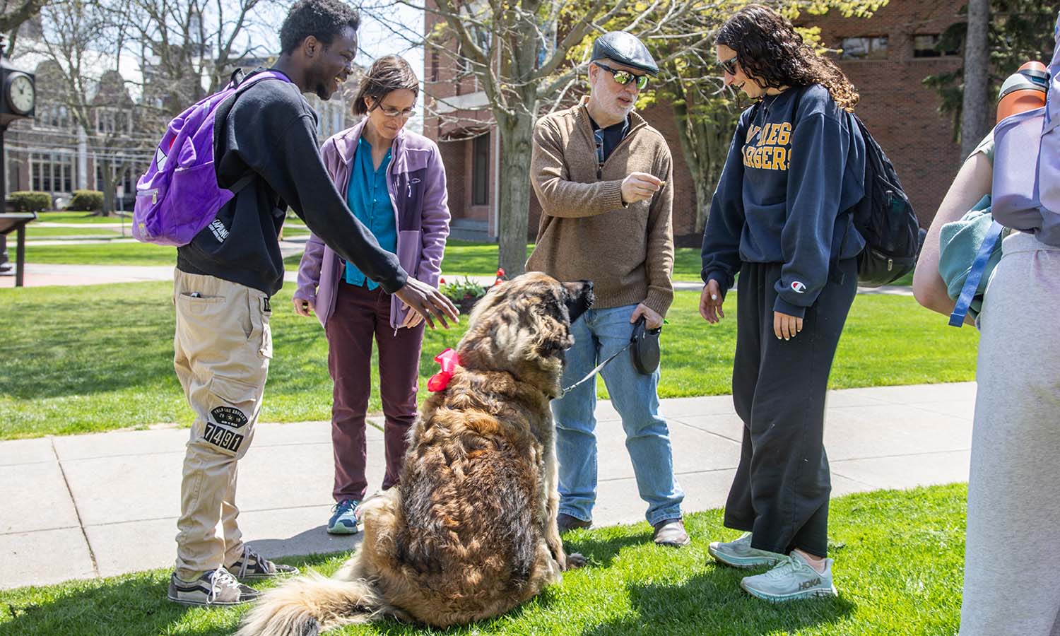Professor of Philosophy Eric Barnes and his dog Elfie visit with students during the Paws for a Break event outside Scandling Campus Center. 
