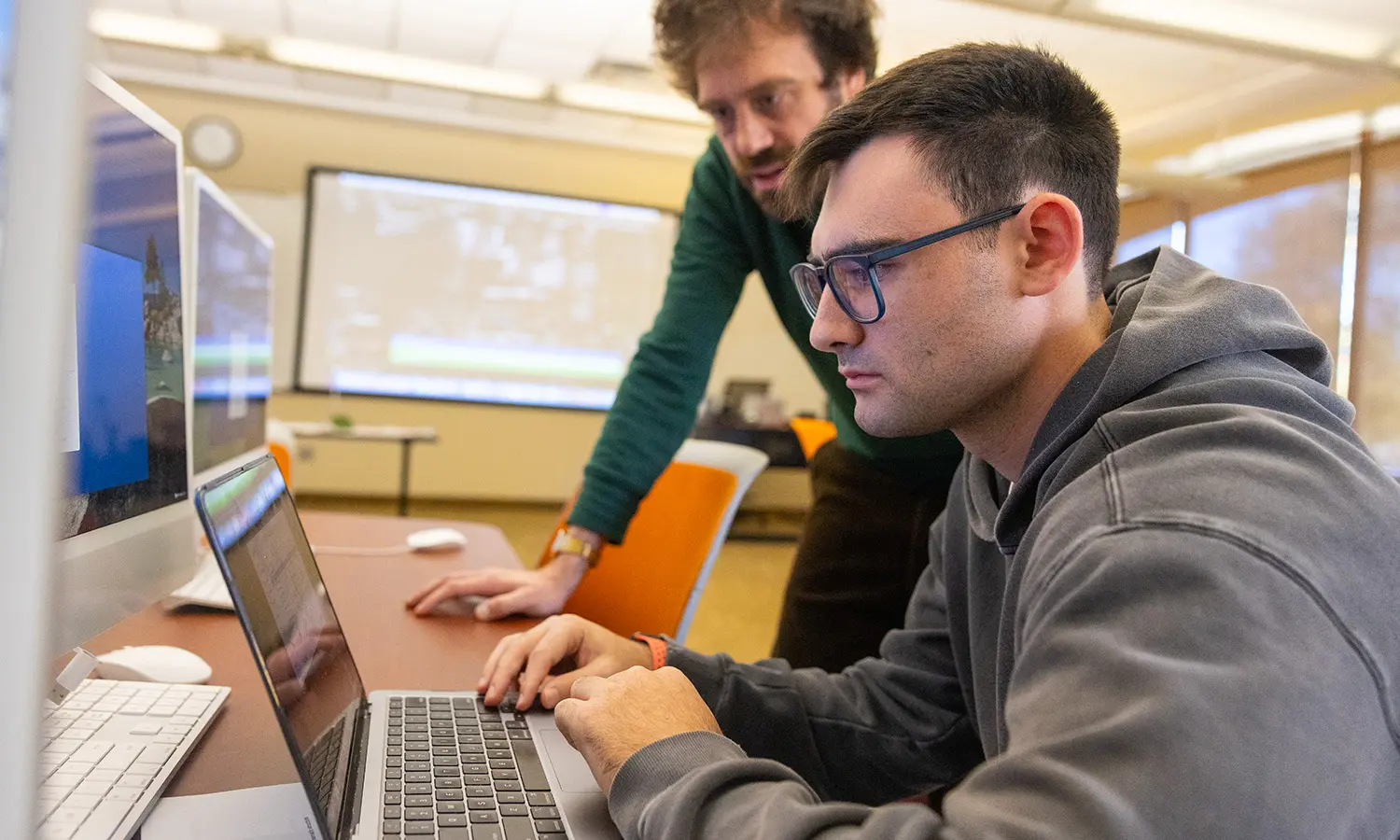 Professor of Practice in Media and Society Casey Puccini assists Hugo Maggio '27 during "Film Editing."  