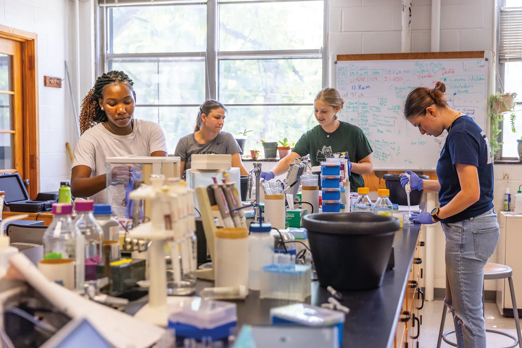 Students working with Professor Kristin Slade in the chemistry lab
