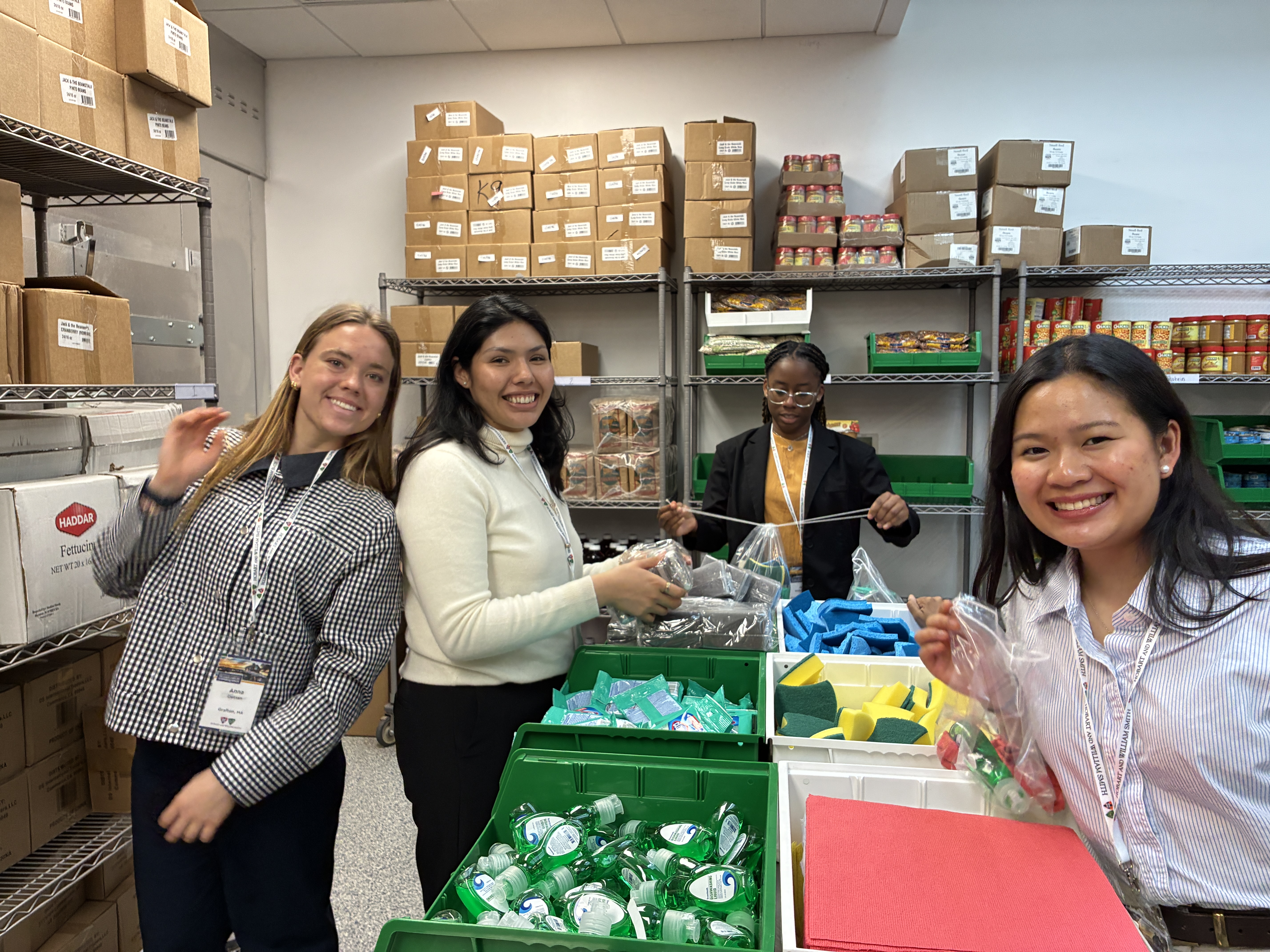 Students pack kits with home goods and sanitary products.