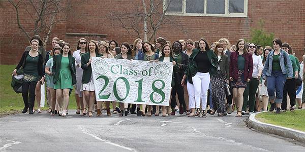 The classes of 2018 walk down from the Hill