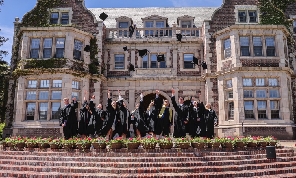 Students throw their caps into the air after graduation
