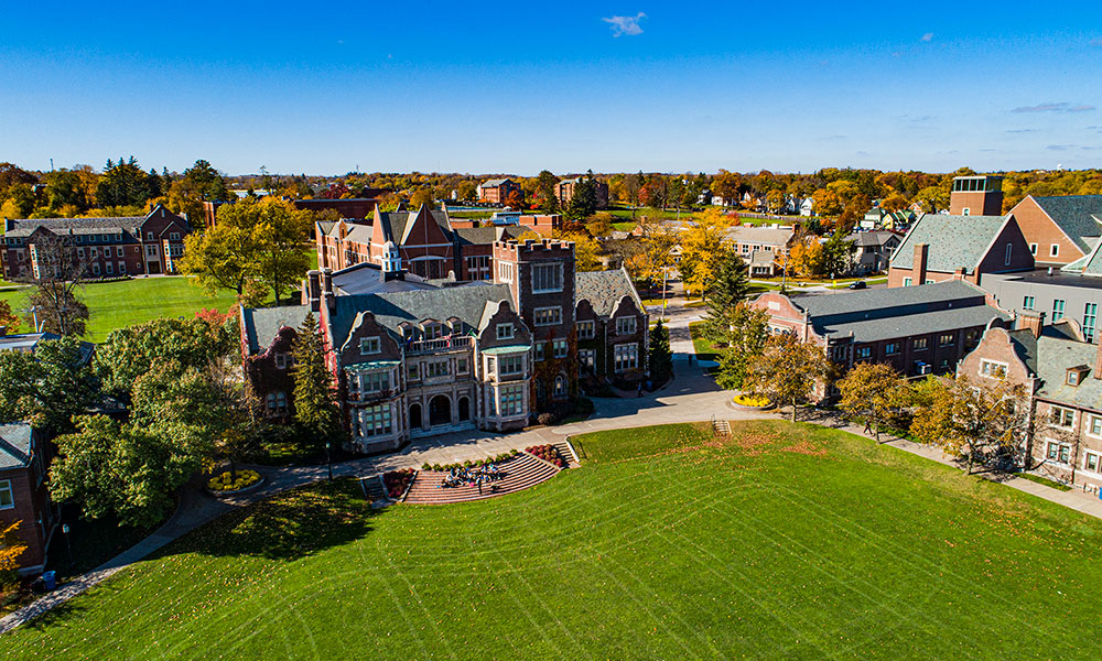 An aerial view of a class on the steps of Coxe Hall