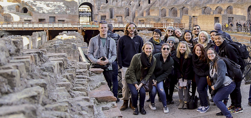 Students gather for a photo at the Colloseum 