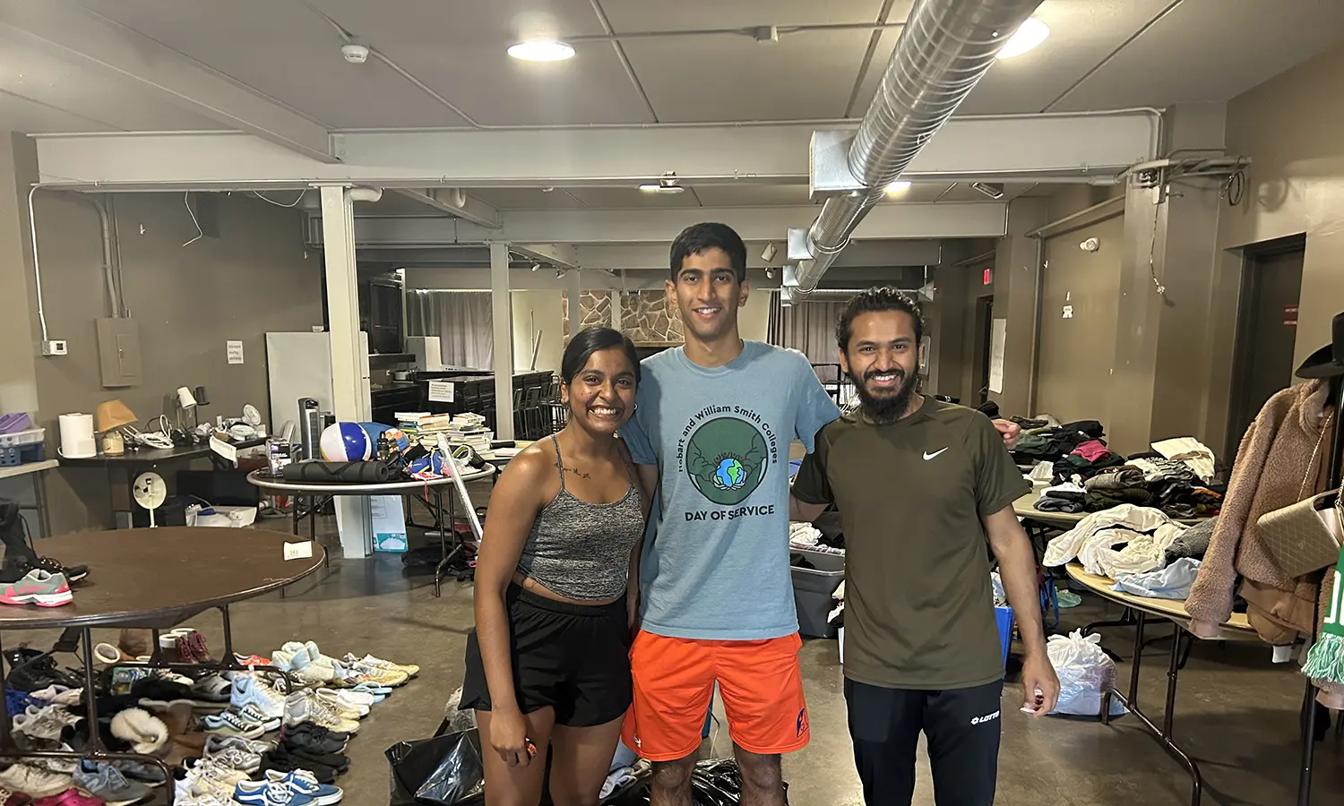 Anjalee Wanduragala '25, Tarang Malhotra '26, and Khairul Islam '25 organize donated materials and prepare them for transport to local community organizations at the HWS Barn.