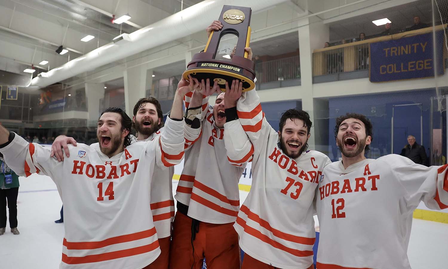 Hobart hockey captains raising trophy