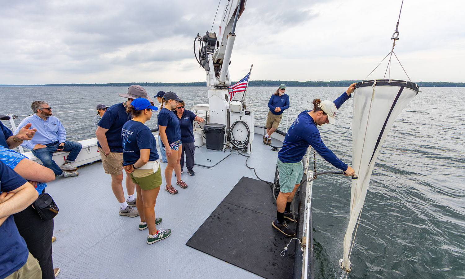Students collect plankton samples from the Seneca Lake water column for stable isotope analysis.