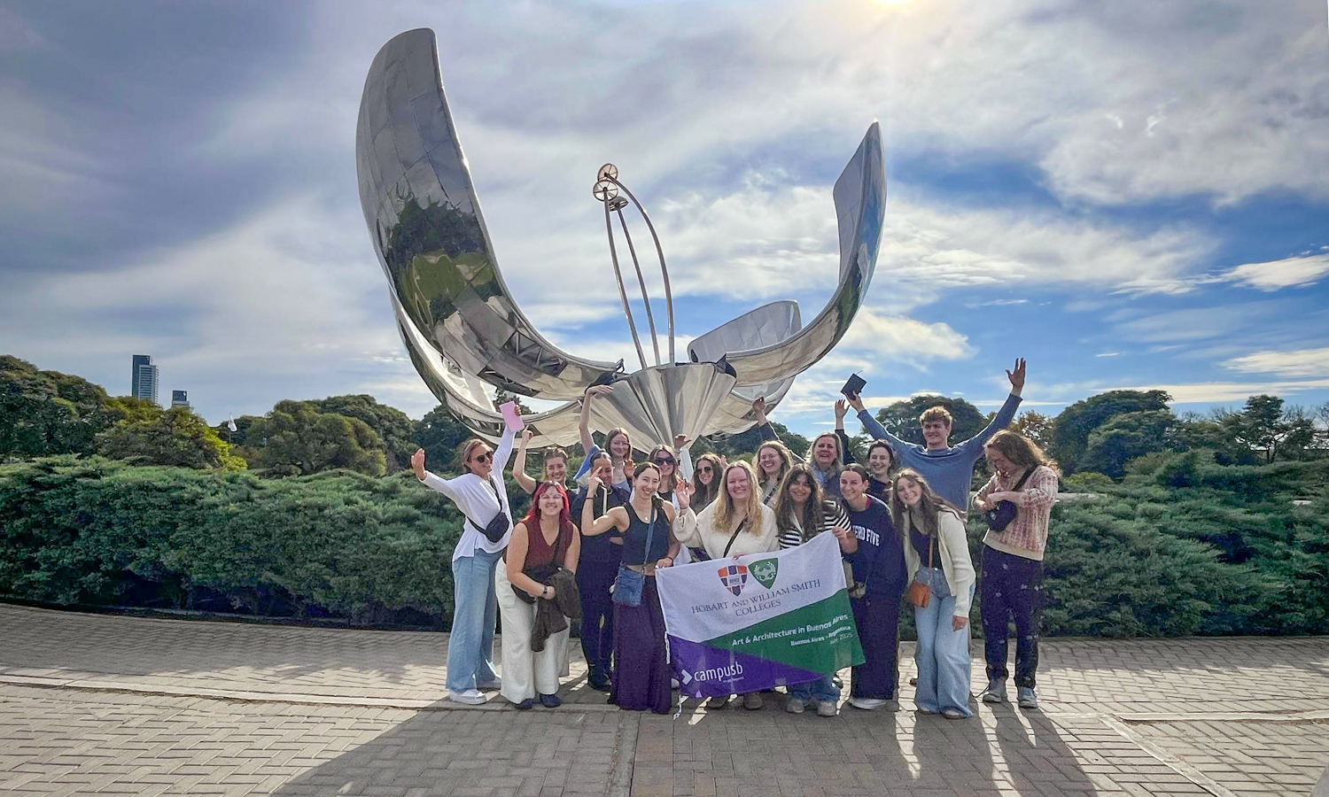 Students pose for a photo in front of Floralis Genérica.