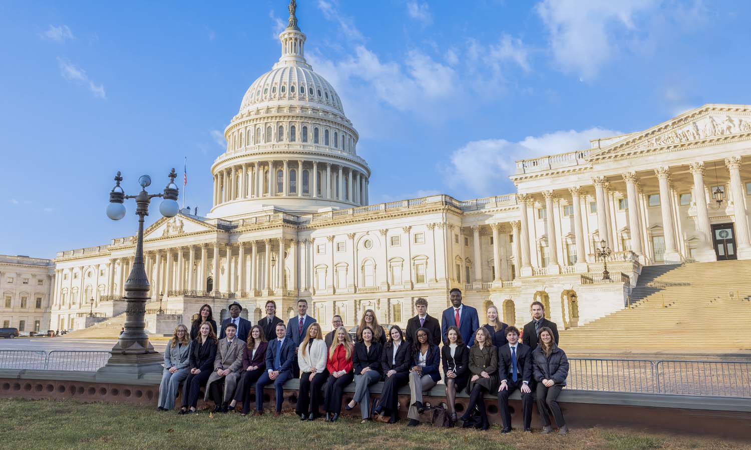 Students, faculty and staff pose for a picture in front of the United States Capitol Building. 