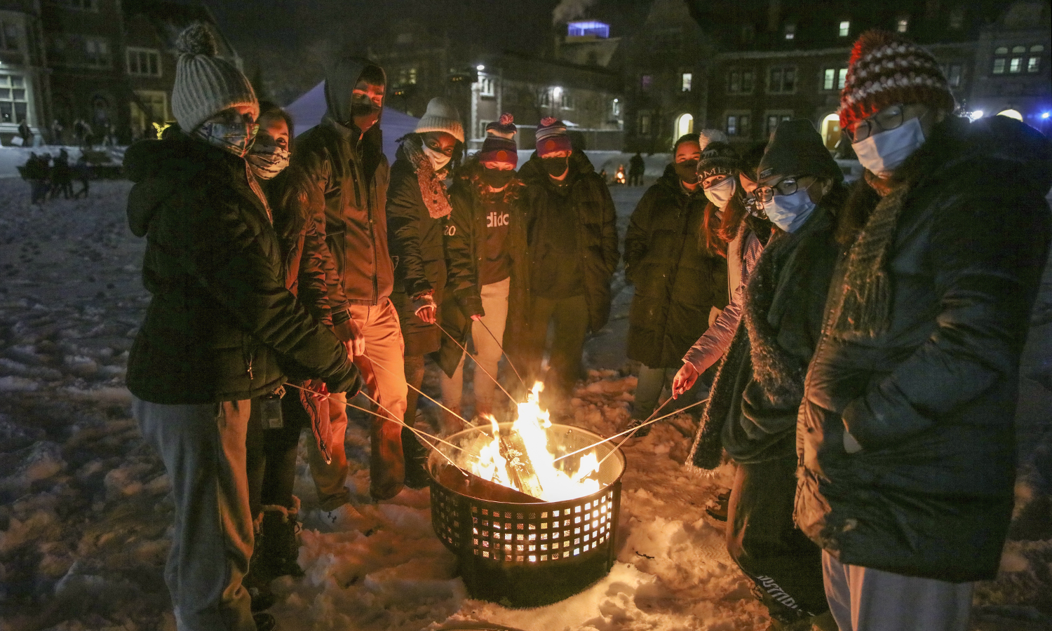 Students gather around a bonfire