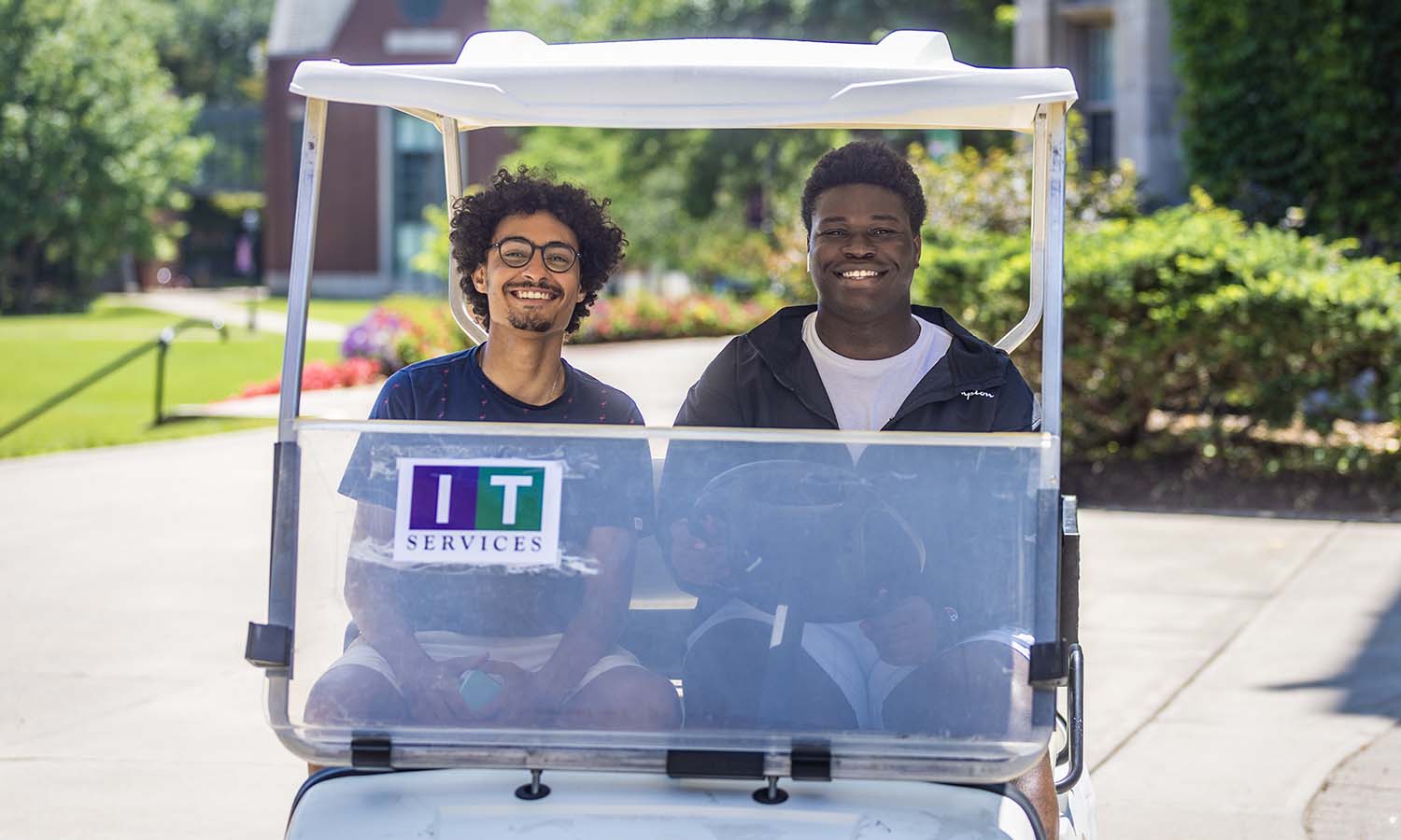 Taha Elhaddad ’25 and Godson-Kemfon Umoren '25 smile for a photo while working for IT Services this summer.