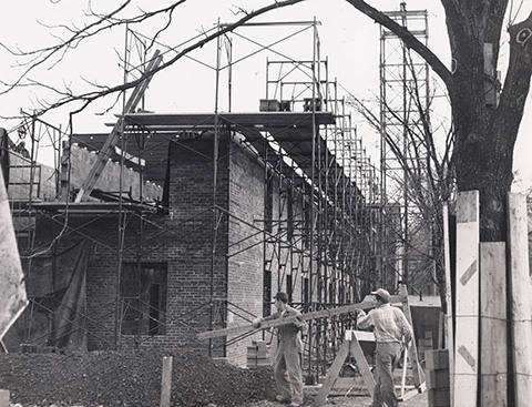 Construction of Bartlett Hall on Nov. 13, 1950, from the Historic Photographs archives. Behind Bartlett, on the right, part of one remaining barracks is visible.