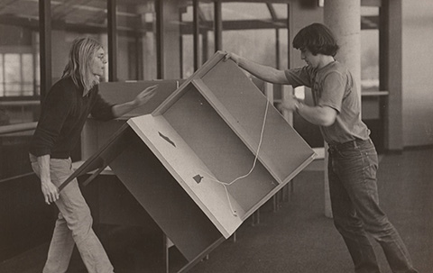 Students studying in the Warren Hunting Smith Library in 1976 and librarians moving the books and desks from the Demarest Library to the newly built library.