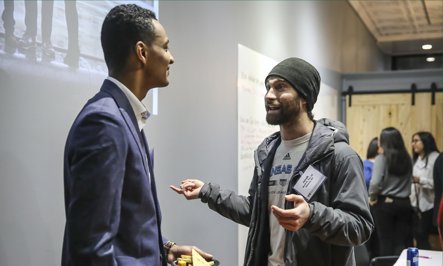 Kwame Morris â19 chats with CEO at Closed Loop Systems LLC and Climate Smart Coordinator for the Town of Geneva Jacob Fox â16 during the Young Alum Happy Hour at the Bozzuto Center for Entrepreneurship. Morris recently accepted a job with the Bozzuto Group in Miami, FL.